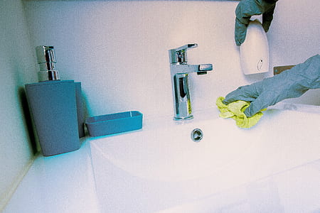 photo of person wearing gray gloves near faucet thumbnail