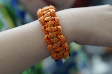 person wearing orange hiker's bracelet thumbnail