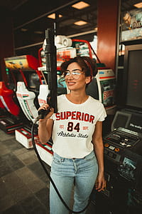 woman holding arcade rifle inside arcade thumbnail
