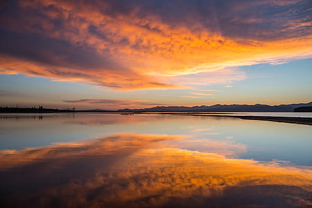 landscape photograph of body of water during golden hour thumbnail