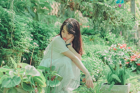 Woman Sit Squats in Garden thumbnail