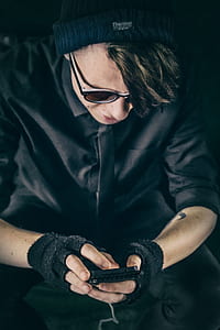 man holding smartphone while sitting thumbnail