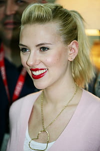smiling woman wearing pink top thumbnail