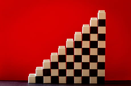 White and Black Checkered Brick Toys Stacked on Top of Each Other Forming Ladder thumbnail