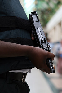 person holding black UZI submachine gun thumbnail