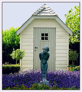 person statue near white wooden shed thumbnail