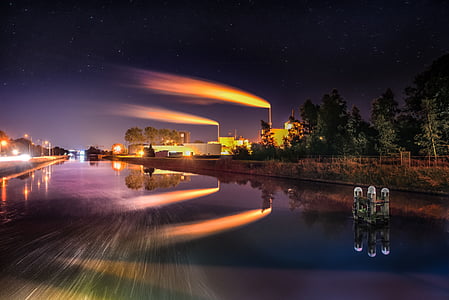 time lapse photography of body of water near light post and trees thumbnail