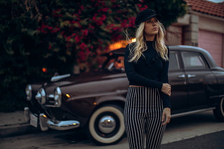woman standing beside Champion Studebaker thumbnail
