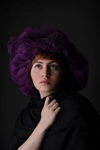 woman wearing black top in front of black wall thumbnail