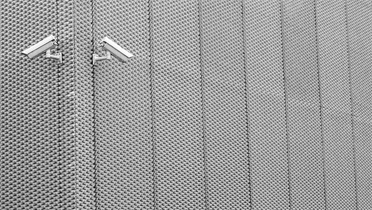 two gray surveillance cameras on gray wall thumbnail