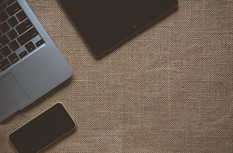 black iPad on brown textile thumbnail