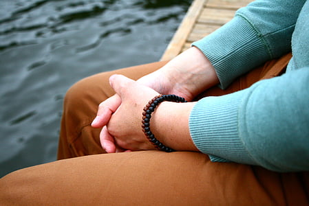 person wearing teal long-sleeved shirt and brown pants thumbnail