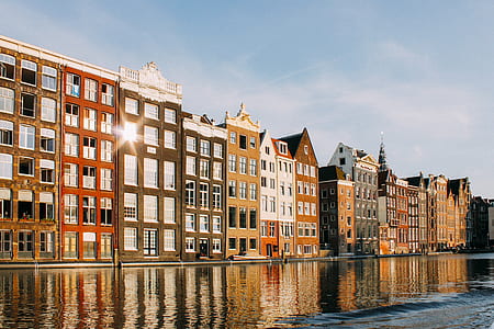 multicolored building beside body of water thumbnail