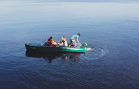 people on teal boat thumbnail