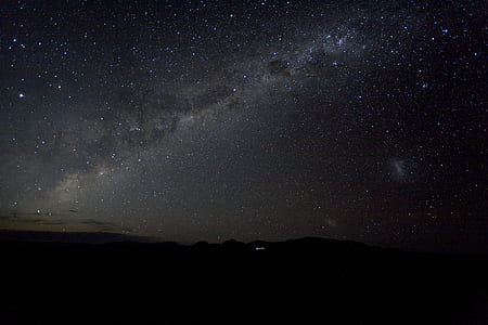 silhouette of mountain under starry sky thumbnail