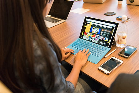 Woman in Gray Long-sleeved Top Using Laptop thumbnail