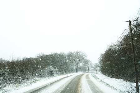 asphalt road covered with snow thumbnail