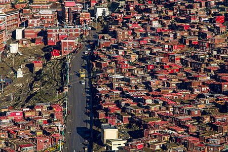 aerial view of red painted building and houses with main concrete road thumbnail