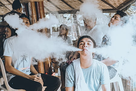 group of men using vape inside brown wooden house thumbnail