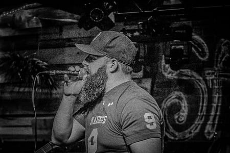 Monochrome Photography of a Man Singin thumbnail