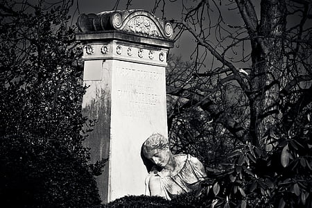 person leaning on concrete pillar statue thumbnail