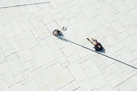 two persons on white concrete floor thumbnail