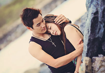 man hugging woman near stream during day thumbnail