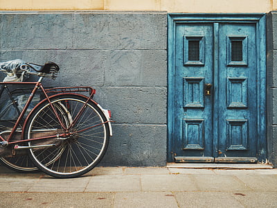 brown city bike near blue door thumbnail