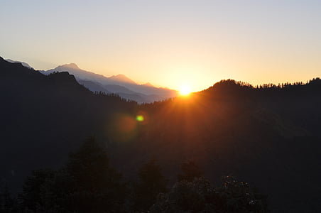 silhouette photography of trees and mountains thumbnail