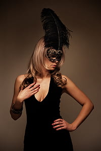 woman wearing black masquerade mask and black scoop-neck sleeveless dress thumbnail