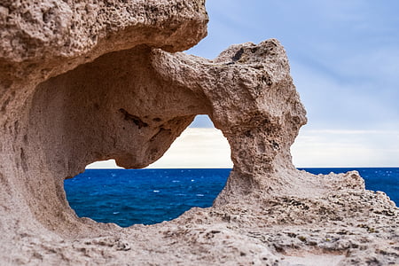 cliff mountain fronting body of water thumbnail
