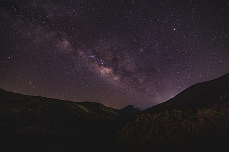 landscape photography of mountain range under milky way thumbnail
