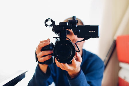 man holding black Sony cam recorder thumbnail