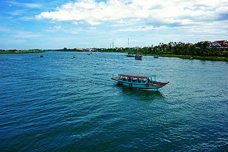 white and red boat sailing on large body of water thumbnail