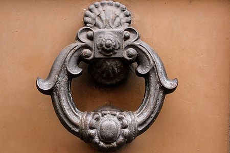 gray door knocker mounted on brown surface thumbnail