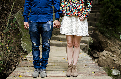 woman and man standing beside each other on pathway thumbnail