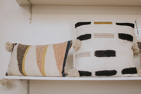 two throw pillows on white wall-mount shelf thumbnail