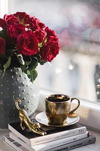 Gold cup of coffee and red roses bouqet thumbnail