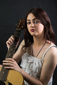 woman holding guitar thumbnail