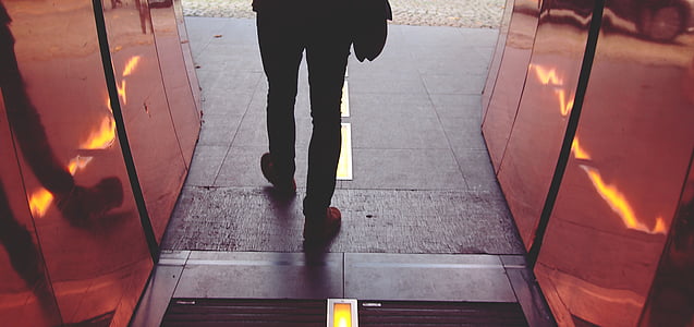 person standing between red walls thumbnail