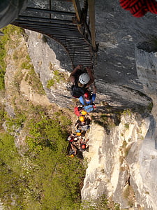 people climbing on black metal ladder during daytime thumbnail