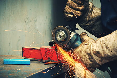 person cutting metal bar with angle grinder thumbnail