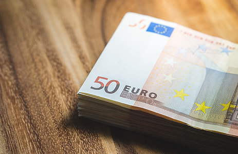 50 Euro banknotes on brown wooden surface thumbnail