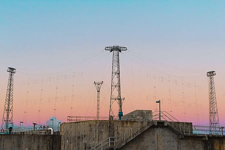 gray electric tower near buildings thumbnail