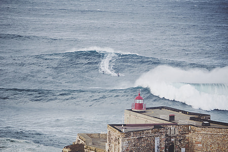 two people surfing on sea thumbnail