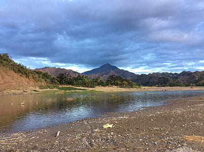 Green and White Mountains Near Body of Water thumbnail