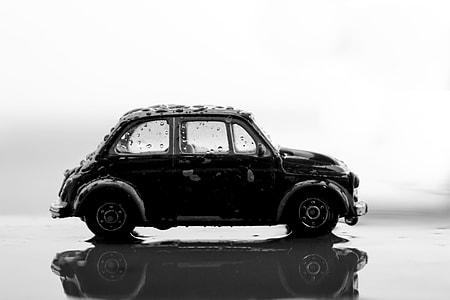 black car reflecting on water surface thumbnail