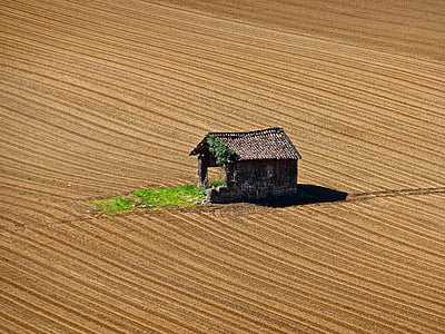 brown house in the middle of desert aerial photography thumbnail
