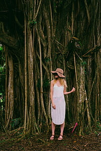 woman standing in front of brown tree thumbnail