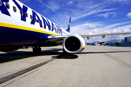 blue and white commercial plane at runway thumbnail